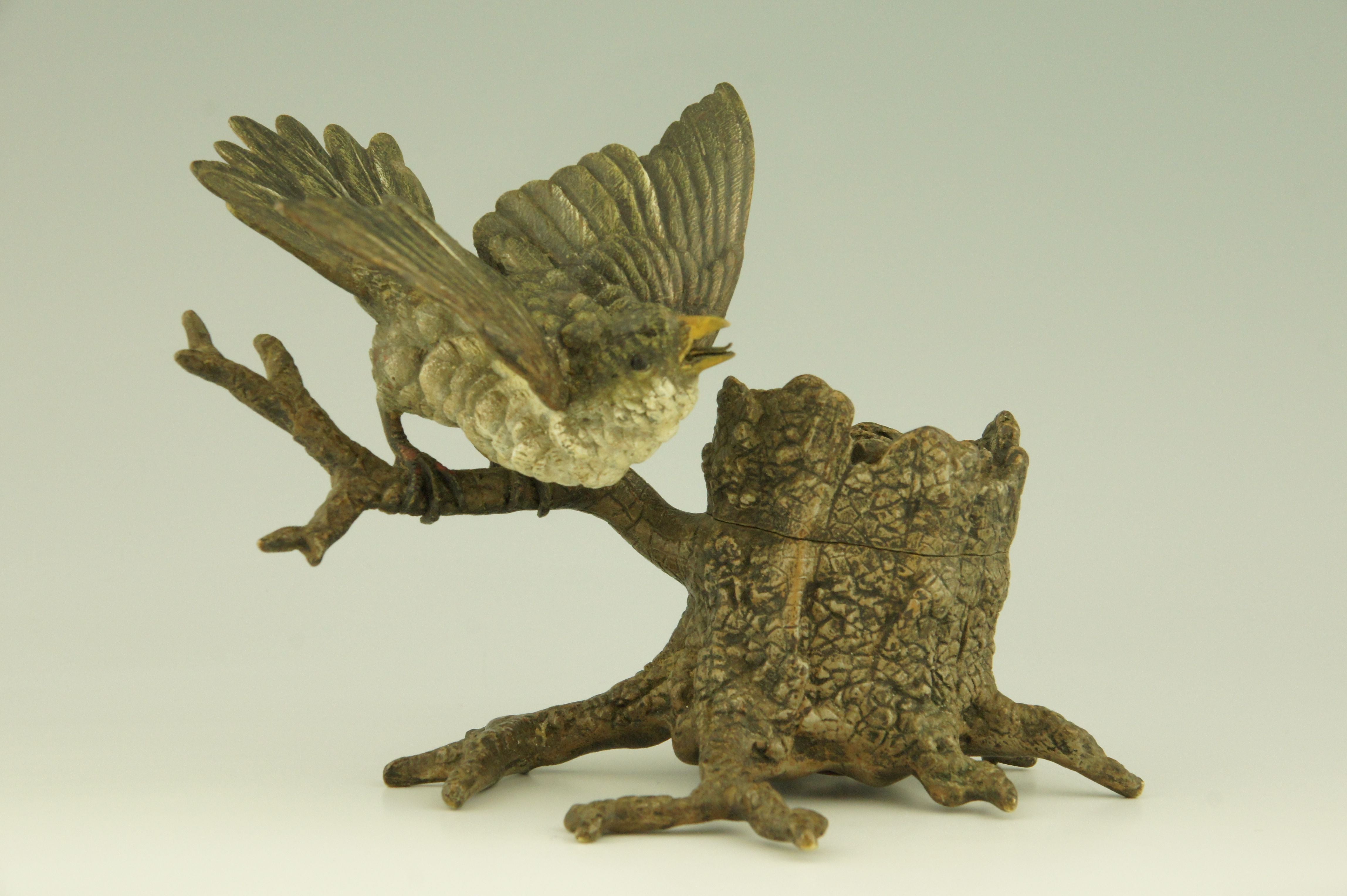 Antique Vienna bronze inkwell with bird perched on a tree trunk.