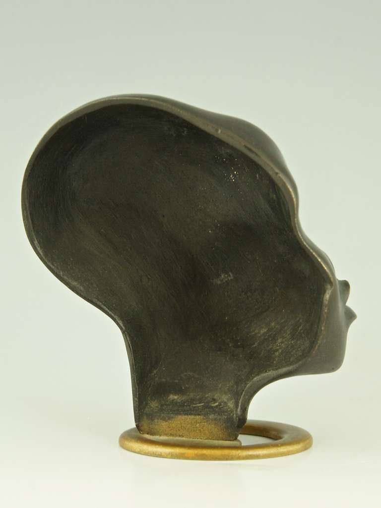 A Head of an African Woman with Earring on Oval Base by F. Hagenauer 1