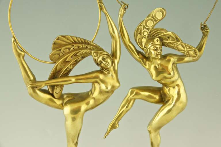 A pair of Art Deco bronze dancers by J.P. Morante, France 1925.
The nudes are wearing stylized head dresses, one is holding a rope the other a hoop. Both on circular green marbles bases. 

Signature/ Marks: Morante.
Style:  Art Deco.		
Date: 