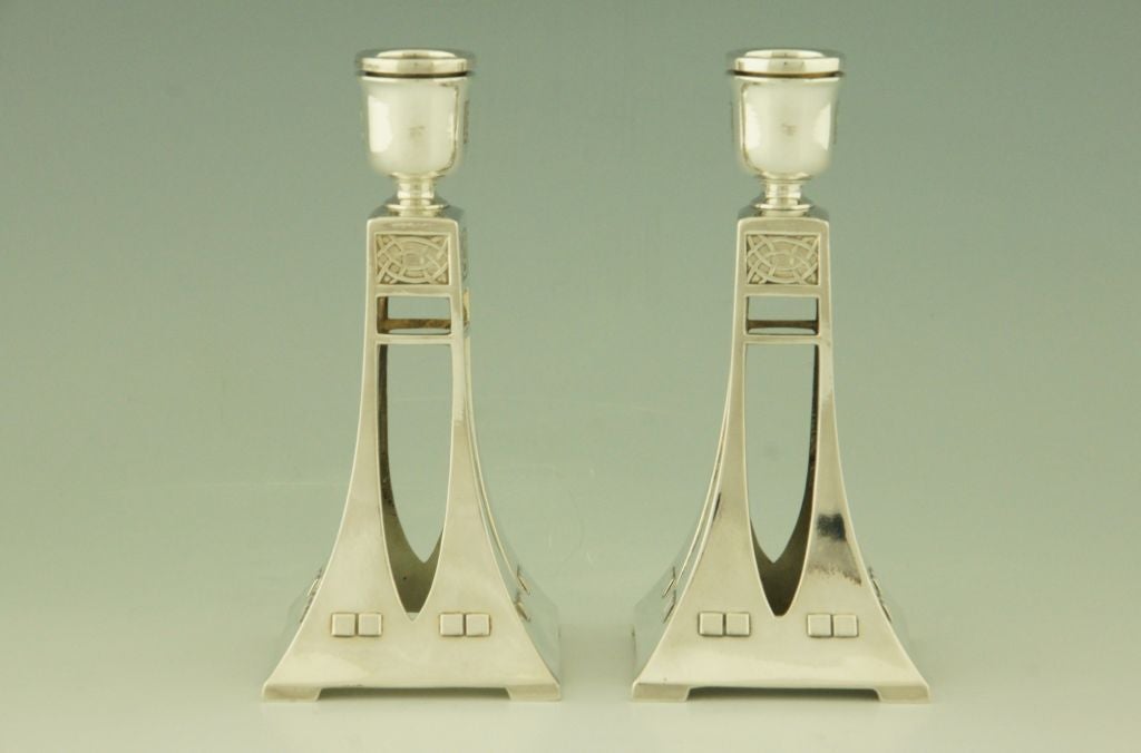 A pair of candlesticks with geometrical forms by WMF. 

Fedex shipping: $ 125.

A picture of this model is shown on page 114 of the book
”Art nouveau domestic metalwork from Württembergische Metallwaren Fabrik 1906” published by the antique