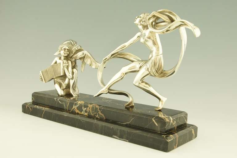 An elegant Art Deco bronze of a scarf dancer with a musician sitting under a palm tree playing an accordion by A. Soleau. 

Fedex shipping: $ 125 

