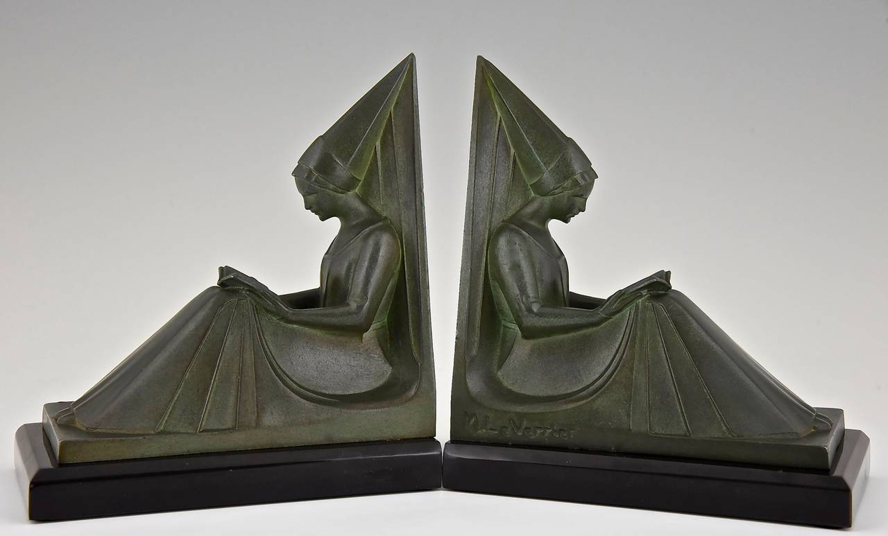 A pair of Art Deco figural bookends in the form of reading ladies. 
Artist:  Max Le Verrier. 
Signature: M. Le Verrier.
Style:  Art Deco. 
Date:  1925-1930.

Material: Green patinated metal.  Marble base. 
Origin: France. 
Size of one: