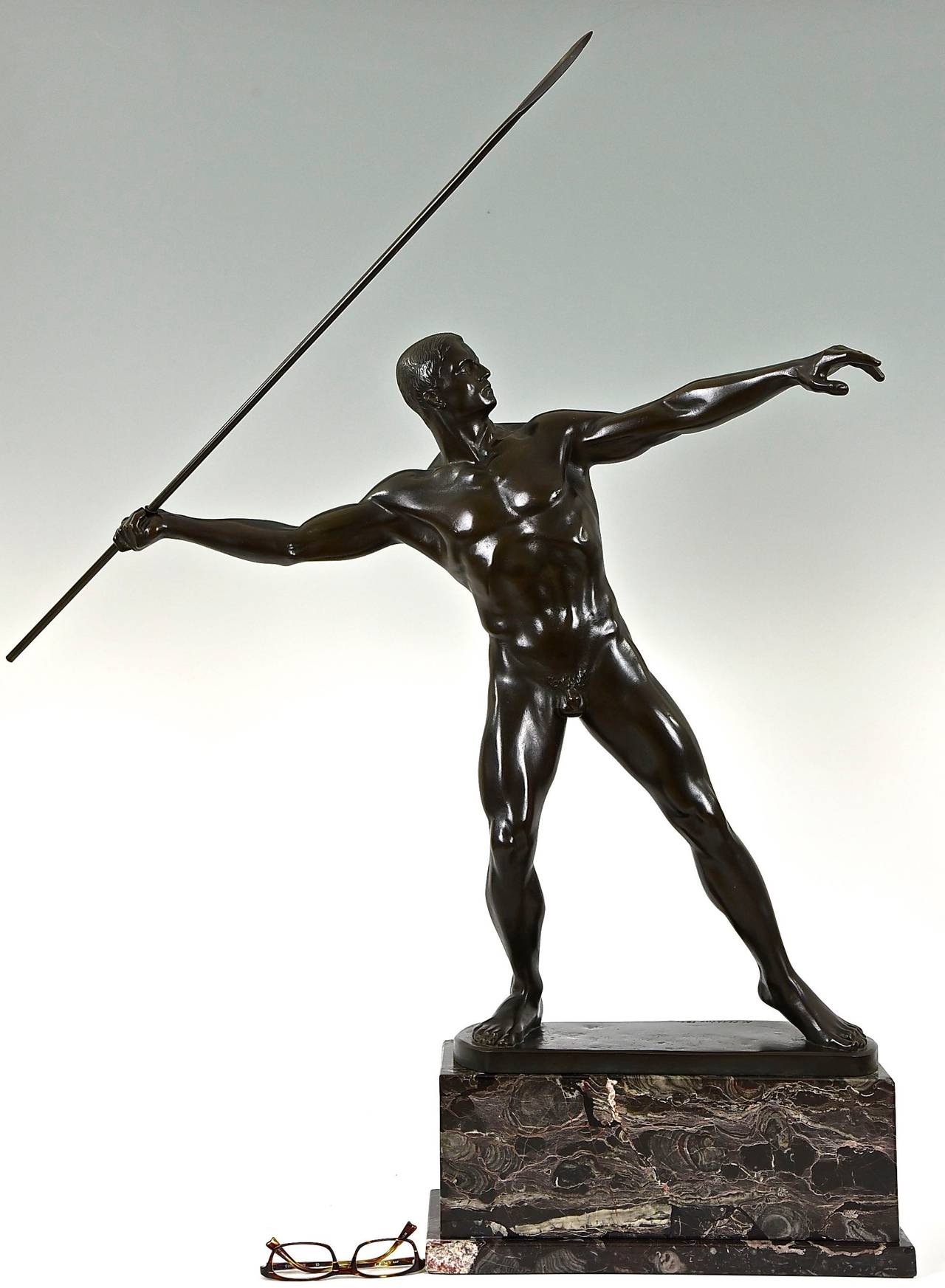 Art Deco bronze of a javelin thrower. H. 38 inch.
By Karl Möbius, Germany, 1876-1953.
Signature: K. Möbius.
Date:  1921.
Material: Black patinated bronze.  Marble base.
Origin:  Germany. 

Size of the male nude with spear:
H. 37.8 inch x