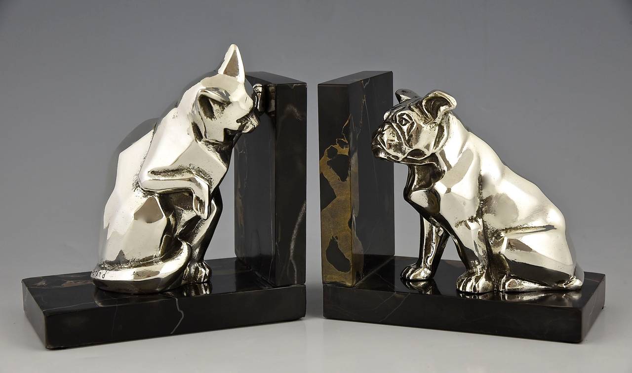 Art Deco silvered metal bookends with cat and bulldog. 
By Irenée Rochard. 
Signature:  Rochard.
Style:  Art Deco. 
Date:  1930.

Material:  Silvered metal.  Portor marble base. 
Origin:  France. 
Size of one:
 H. 6.1 inch. x L. 5.5 inch X
