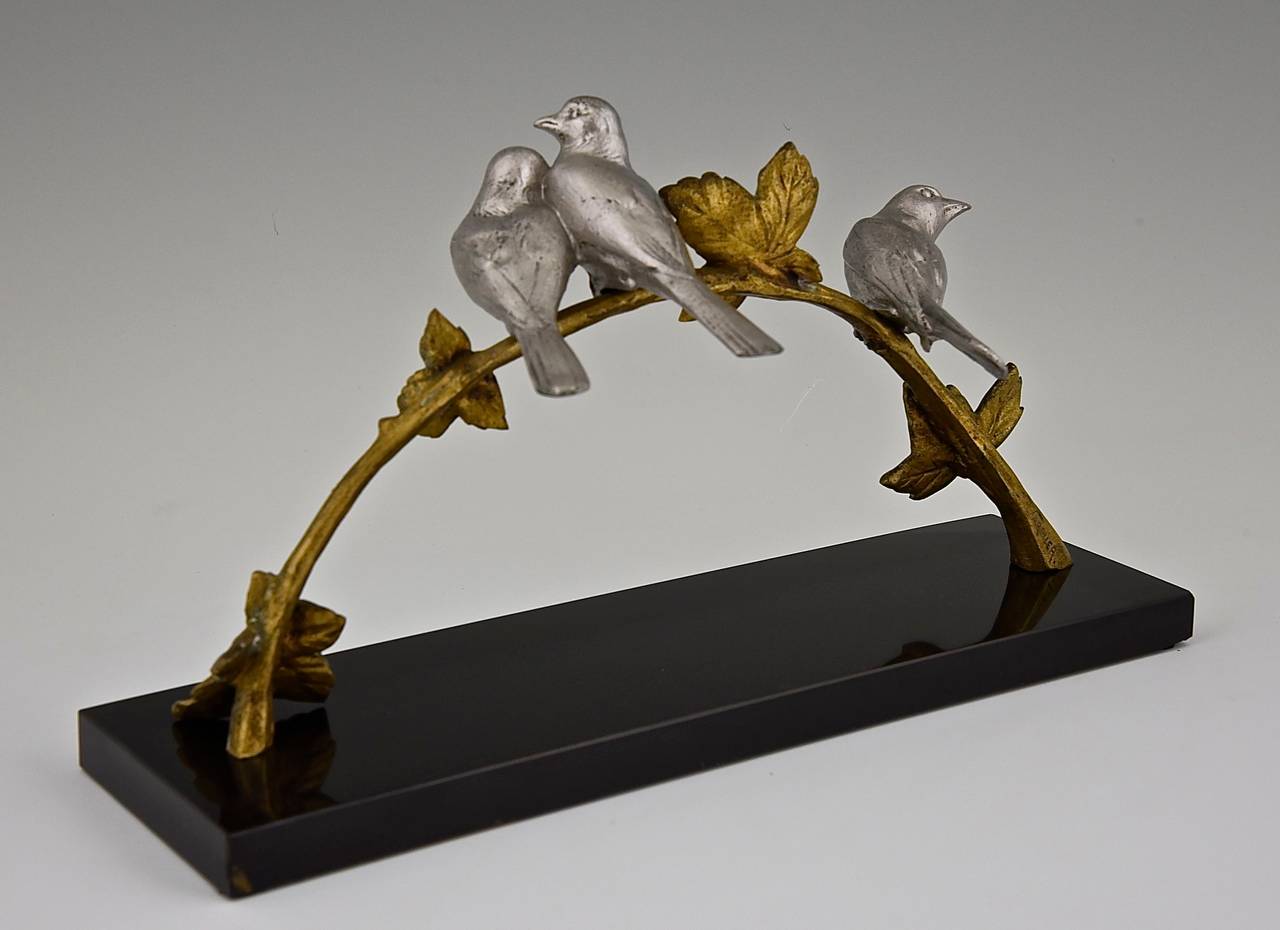 Description:  Art Deco bronze sculpture of three birds on a branch. 
Artist:  Varnier.
Signature:  R. Varnier. 
Style:  Art Deco. 
Date:  circa 1930.

Material:  Bronze with silver and golden patina.  Marble base. 
Origin:  France. 
Size:
