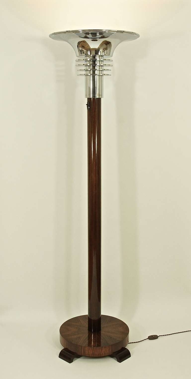 A wood and chrome floor lamp.