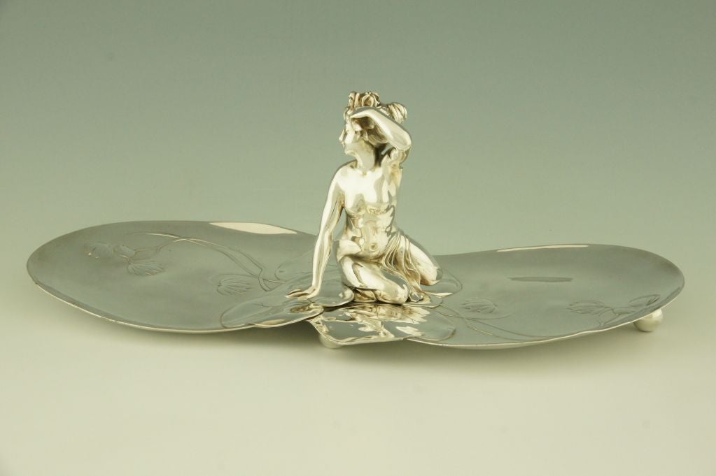 Art Nouveau sweet and fruit dish with nude and water lilies.

Stamped AK for Albert Kohler, Austrian firm that was taken over by & WMF, Württembergische Metallwaren Fabrik.