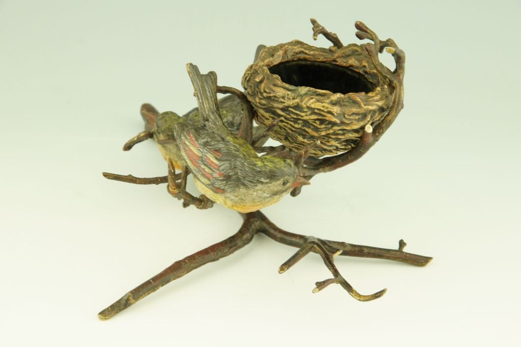 Fedex shipping: $145

A cold painted Vienna bronze with two birds on a branch building a nest. The nest can be used as a jewelry tray. The inside is covered with velvet. 

Literature:
Similar models but smaller are shown on page 13. “Antique