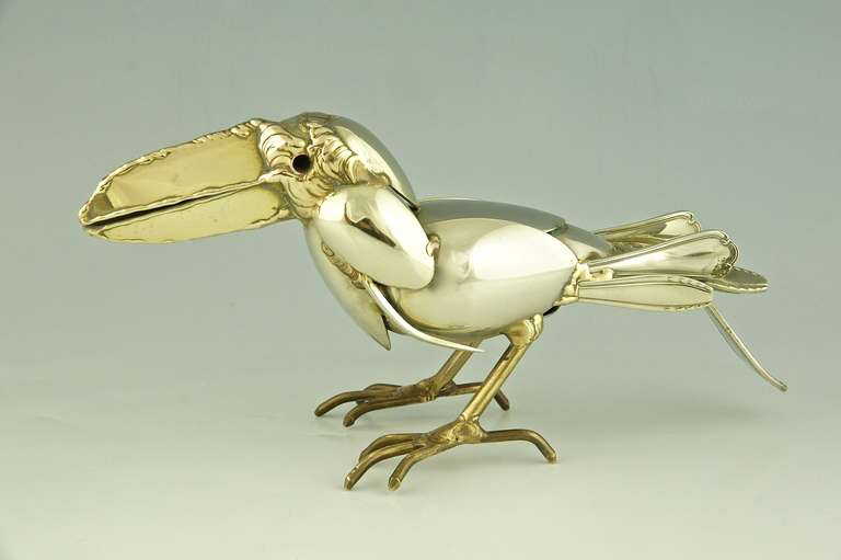 A sculpture of a Tucan made of antique forks and spoons. 
Artist: Gerard Bouvier, born in France in 1942.
Signature: Gerard Bouvier, 85 / 611.	 
Style: Modern.		
Date: 1985.
Material: Silver plated and polished metal.
Origin: France.
