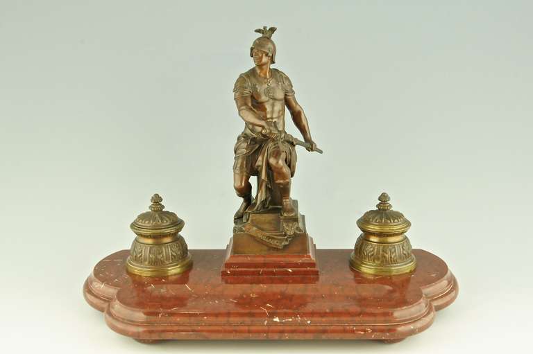 La Vaillance or Courage. 
Bronze and marble inkwell by Emile Louis Picault (1839-1915) Paris. 
Signature & Marks E. Picault,  Salon des Beaux Arts, 1896.	
Style: Romantic.		
Date: 1896.		

Material: Patinated bronze and red Belgian marble.