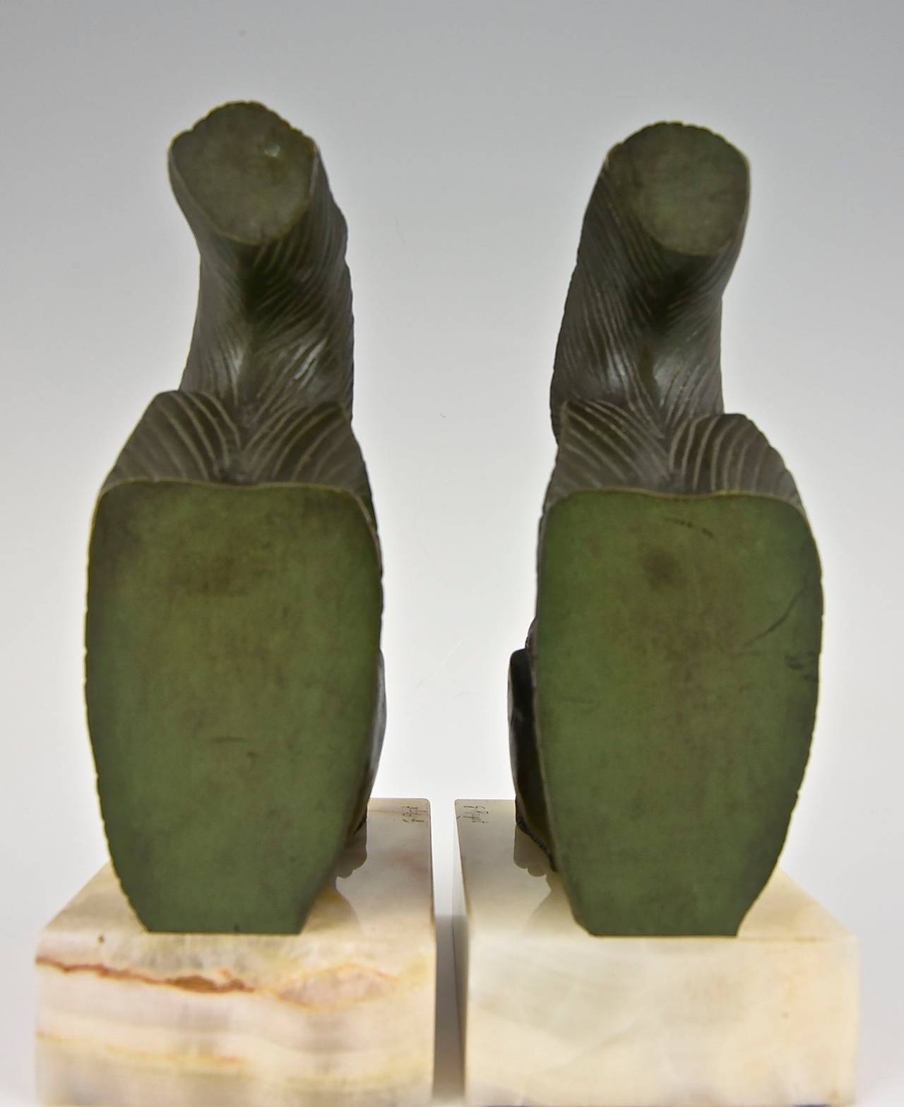 Art Deco bronze squirrel bookends.
Artist:  Georges Rigot.
Signature: G. Rigot.
Style:  Art Deco.
Date:  1930.
Material: Green patinated bronze.  Onyx bases.
Origin:  France.
Size of one:  
H. 7.1 inch x L. 3.8 inch x W. 3.8 inch.
H. 18 cm.