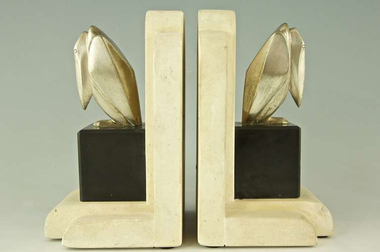 Pair of Art Deco cubist pelican bookends. 
By Georges H. Laurent.

Signature:”¨ G.H. Laurent
Style:”¨ Art Deco.		
Date:”¨ 1925.			
Material:”¨ Bronze with silver patina. ”¨Marble and stone base. 
Origin: ”¨France. 			

Size of one:	
H. 7.5