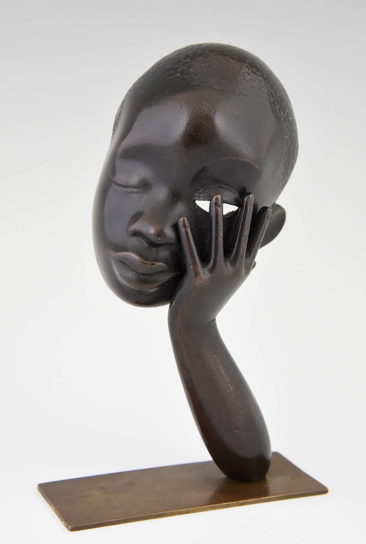 Bronze head of an African woman. 
By Hagenauer. 
Signature and marks:  
WHW, Made in Vienna Austria.  Rena. This bronze was sold at Rena Rosenthal’s shop in New York. 

Style: Art Deco.   
Date:  1930-1940.
Material:  Bronze. 
Origin: