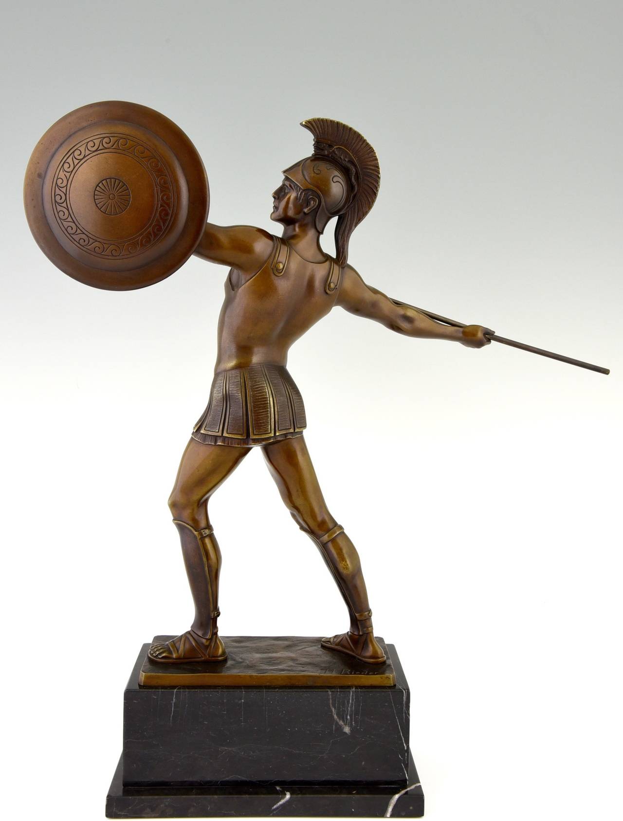 Bronze sculpture of a Roman warrior. 
By  H. J. Rieder. 
Signature:  H. Rieder.

Style:  Art Deco. 		
Date:  1920.			
Material: Patinated bronze.  Marble base. 	 
Origin:  Germany. 			

Size:			 
H. 19.3 inch x L. 17.7 inch x W 4.7 inch.