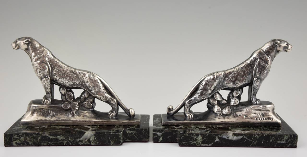 A pair of Art Deco panther bookends.
Artist: Maurice Frecourt.
Signature: Frecourt.
Style: Art Deco.
Date: circa 1930.
Material: Metal with silver patina. On green marble bases.
Origin:  France. 

Size:
H 5.3 inch x L 6.9 inch (size of one)