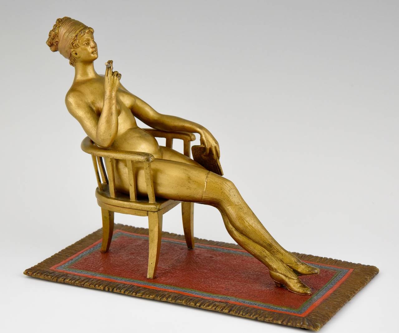 Erotic cold painted Vienna bronze, nude sitting in a chair smoking a cigarette on an oriental carpet.

Literature:
A similar model is illustrated on page 167 “Bronzes de Vienne” by Ernest Hrabalek, les éditions de l'amateur.
More information