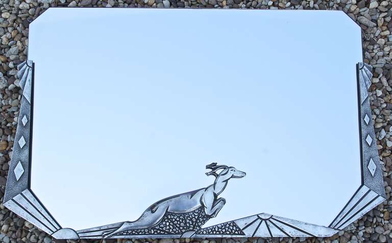Art Deco mirror with leaping deer and beveled glass. 
By L. Charles,  8 Cours Lafayette  Lyon.

Size:			 
H.19.3 inch x L.29.5  inch x W. 1 inch. 
H. 49 cm  x L. 75.5 cm. x W.2.5 cm.
