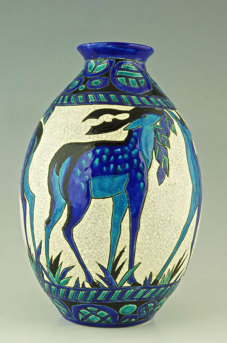 Charles Catteau Art Deco deer vase, from the line Biches Bleues for Boch freres, La Louviere, Belgium. 

Signature & Marks:  
Boch freres seal. 
D 943 (for the decor created between 1924/1925) 
Charles Catteau. 
 Impressed number. 

Date: