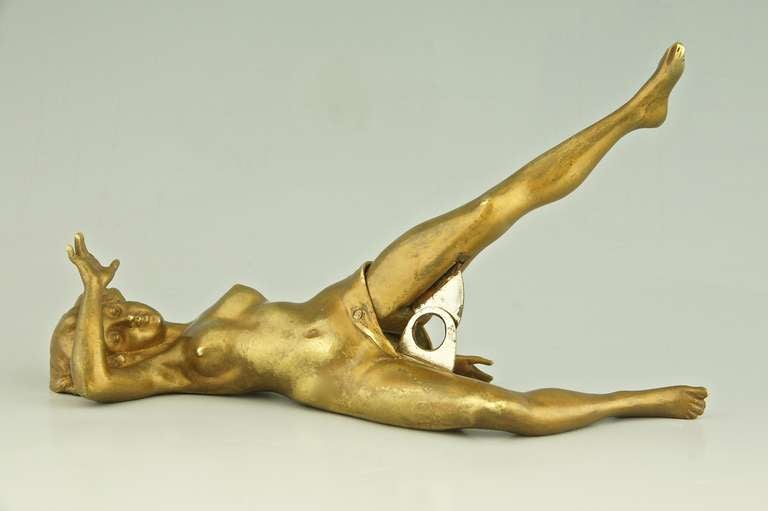 A bronze erotic cigar cutter in the form of a nude.  
Utilitarian moveable, closing legs cuts tip off cigar. 
By one of the ateliers of the Vienna bronzes.

Size :  
H. 4 cm / 9 cm. (leg up) x L. 21,5 cm. x W 9 cm. 
H. 1.6 / 3.5 inch (leg up)