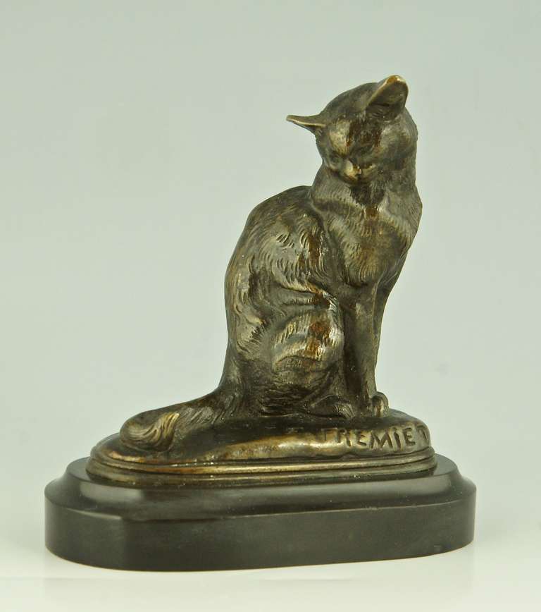 A bronze of a sitting cat.
By  Emmanuel Fremiet, 1824-1910.  
Signature:  Fremiet.
Style:  Romantic. 		
Date:  1880.		
Material:  Patinated bronze on a marble base. 		
Origin:  France. 			
Size:			 
H. 3.7 inch x L. 3.5 inch. x W. 2 inch.