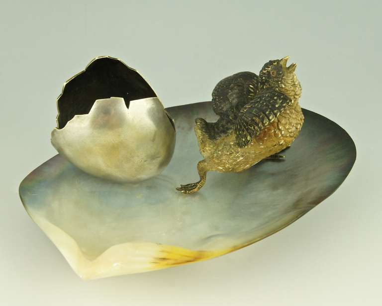 Vienna bronze seashell tray with a young bird next to an egg shell. 
 By one of the ateliers of the Vienna bronzes. 
Style:  Romantic. 		
Date:  1900.			
Material:  Cold painted bronze, silvered bronze, natural seashell. 
Origin:  Vienna,
