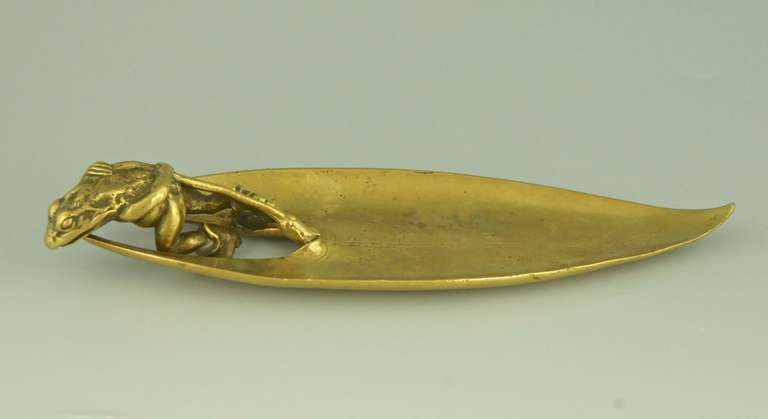 Antique bronze of a frog pulling a leaf.
Signature and Marks: 
