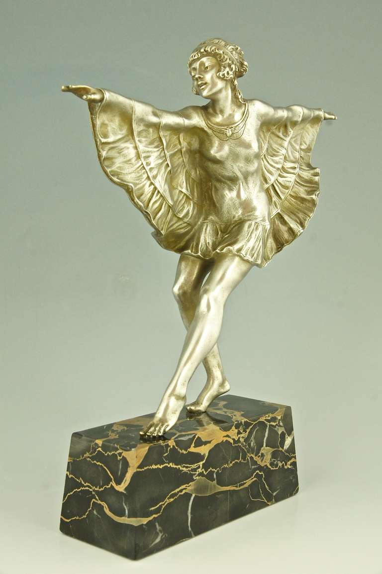 Elegant Art Deco dancer with butterfly dress. 
By  Bouraine, Marcel André 1886-1948. 
Signature: Briand, pseudonym for Marcel Bouraine. 
Style:  Art Deco.		
Date:  Ca. 1925.
Material: Silvered bronze on portor marble base. 
Origin:
