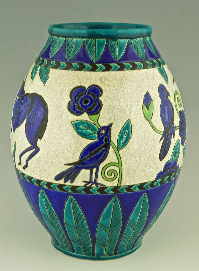 Charles Catteau Art Deco vase with gazelles and birds. Decor Kioto, 1924.

Signature & Marks:  
Keramis made in Belgium stamp.
.D 896 ( created in 1924)
 La Maitrise 
Impressed number. 963

Date: 1924. 
Material:   Ceramic.

Origin: