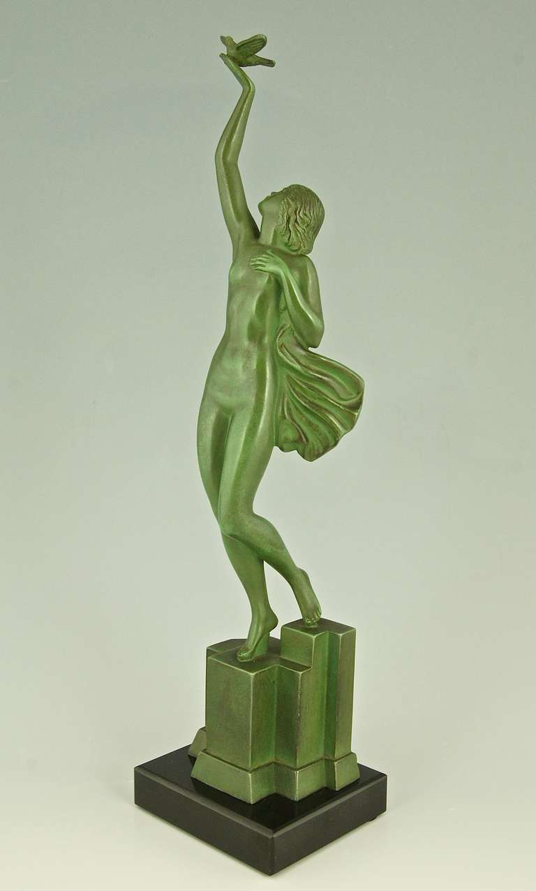 An Art Deco sculpture of a nude holding a dove. 
By Fayral, pseudonym for  Pierre Le Faguays.
Signature: Fayral.
Style:   Art deco.
Condition:  Good original condition, see pictures. 

Date: Ca. 1930.
Material: Metal with green patina.  Black