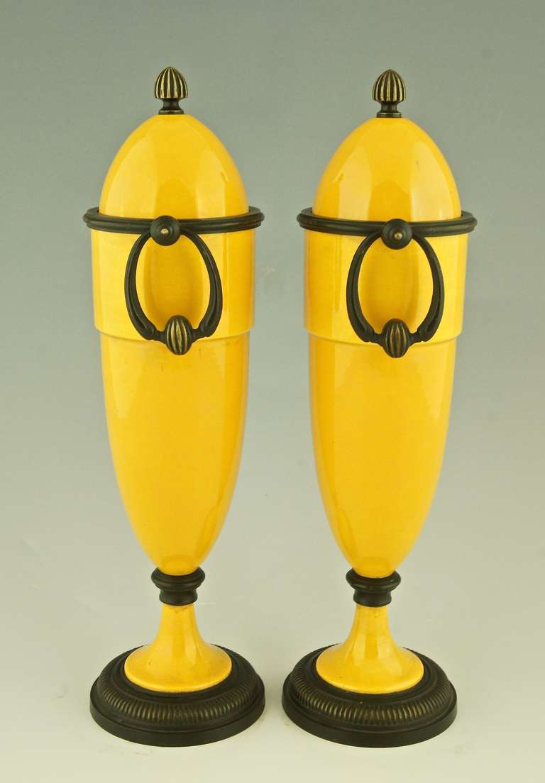 A pair of yellow French Art Deco ceramic vases with bronze mounts.
Artist:  Paul Milet (1870-1950) son of Optat Milet. Maker:  Sèvres. Signature and Marks:  MP and Sèvres. Style: Art Deco. Date: 1925. Material: Ceramic and bronze. Origin: France