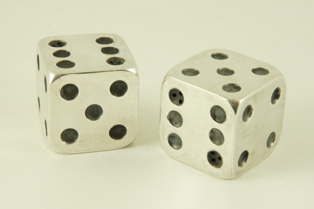 Two dice in silvered metal to be used as salt and pepper dispensers by Gallia, Christofle. Stamped marks and numbers.

Literature:
Metalkunst vom Jugendstil zur Moderne, Karl H. Bröhan, Bröhan Museum Berlin.
150 ans d’orfèvrerie Chrsitofle,