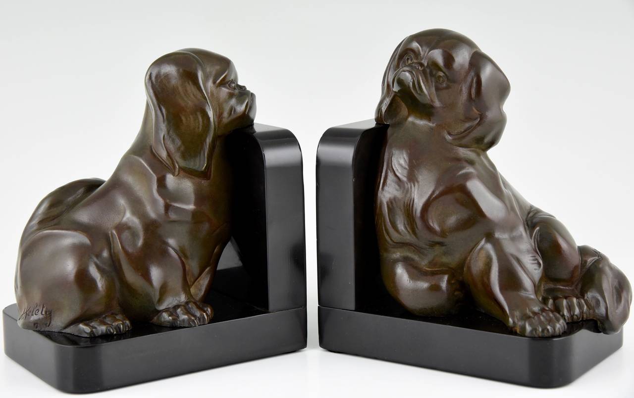 Description:  Art Deco Pekingese dog bookends.
Artist: Alexandre Kelety.
Signature:  A. Kelety.
Style: Art Deco. 
Date: circa 1930. 
Material: Bronze with dark brown patina. Black marble bases.
Origin:  France. 
Size of each:  
H 5.9 inch x