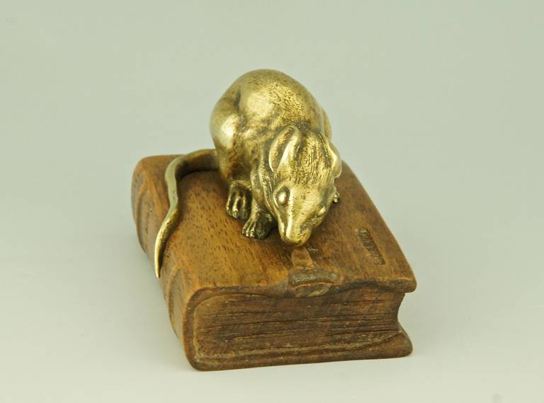 A bronze mouse on a wooden book, can be use a paperweight.
By  L.ouis Albert Carvin.
Signature and Marks :  
L. Carvin on the book and on the bronze. 
Foundry mark Susse Frères, Paris. 
  On the spine of the book:  De la Fontaine  Contes  Susse