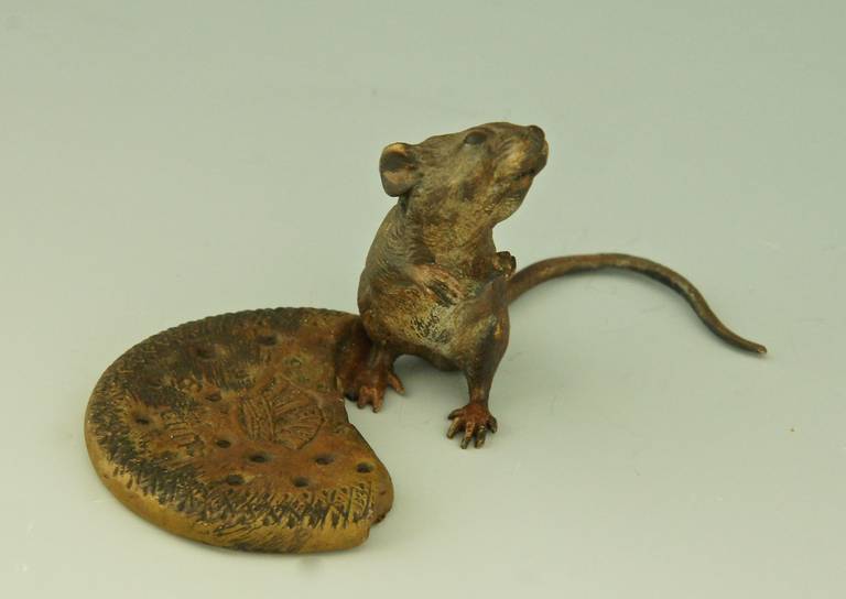 Vienna bronze of a mouse with biscuit.
Marks:  B in vase for Bergman.
Date:  circa 1930. 
Material:  Cold painted bronze. 
Origin:  Vienna, Austria. 
Size: 
H. 2.2 inch. x W. 2.1 cm. x L. 3.9 inch. 
H. 5,5 cm. x W. 5,4 cm. x L. 10 cm.