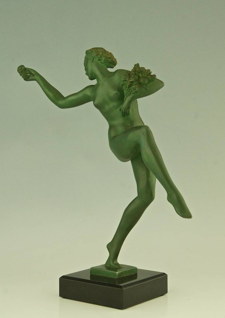 Art Deco nude dancer with flowers. 
By  Fayral, pseudonym for  Pierre Le Faguays.
Signature: Fayral. 
Style: Art deco.
Condition:  Good original condition, see pictures. 

Date: Ca. 1930.
Material: Metal with green patina.  Black marble base.