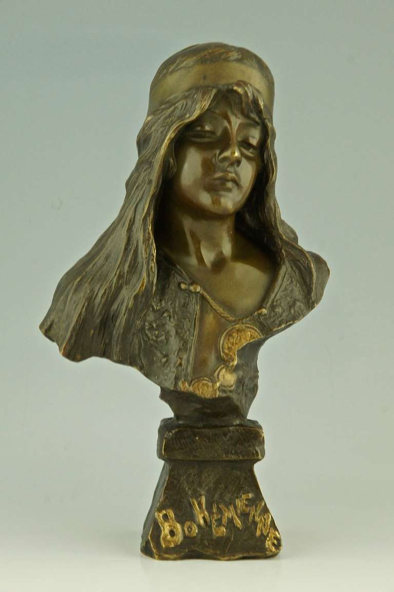 Bohemienne, a bronze bust of a woman wearing a necklace with coins.
By Emmanuel Villanis (1858-1914)
Signature / Marks:  E. Villanis.
Style:  Art Nouveau.		
Date:  1900.		
Material:  Bronze with multicolor patina.  		
Origin:  France. 