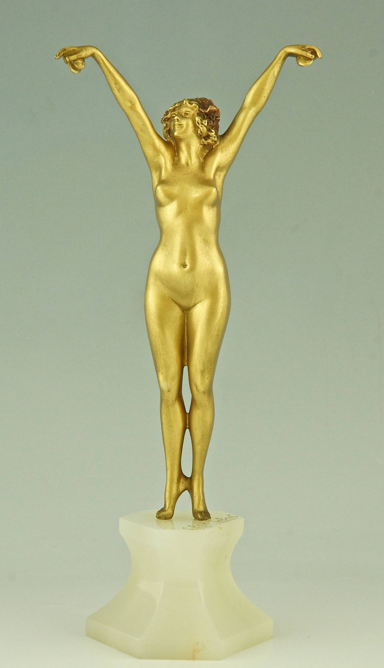 Andalusian, an Art Deco sculpture of a nude with castanets on an onyx base. 
By Claire Jeanne Roberte Colinet,  Belgian sculptress, worked in France. 
Signature or Marks: CL. J. R. Colinet.

Style:  Art Deco. 
Date:  1925. 
Material: Gilt