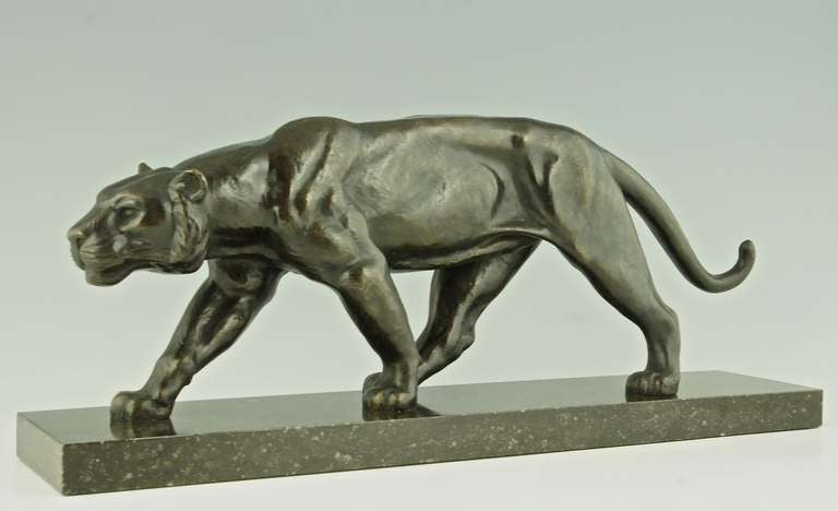 Art Deco bronze of a walking panther. 
By  Alexandre Ouline, Worked in France 1918-1940.
Signature / Marks:  Ouline. 

Style:  Art Deco.	
Date:  1930.
Material:  Bronze on a marble base. 	
		
Size: 
L. 22,8 inch X H. 9.3 inch x W. 4.7 inch.
