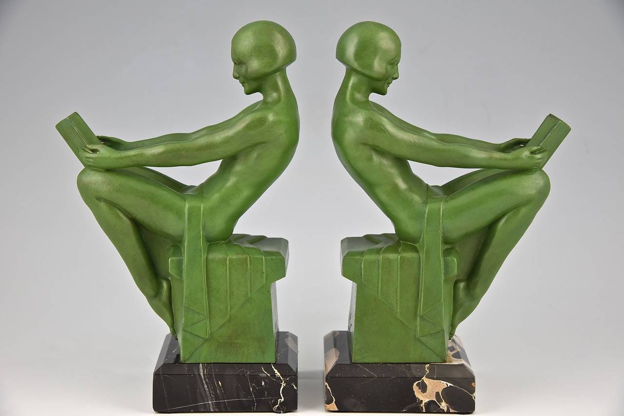 A pair of Art Deco bookends with reading ladies by Max Le Verrier. 
Date:  1930.
Material: Green patinated metal.  Portor marble base. 
Origin:  France. 

Size of one:  
H. 8.3 inch x L. 5.7 inch x W. 3.1 inch
H. 21 cm. x L. 14.5 cm. x W. 8