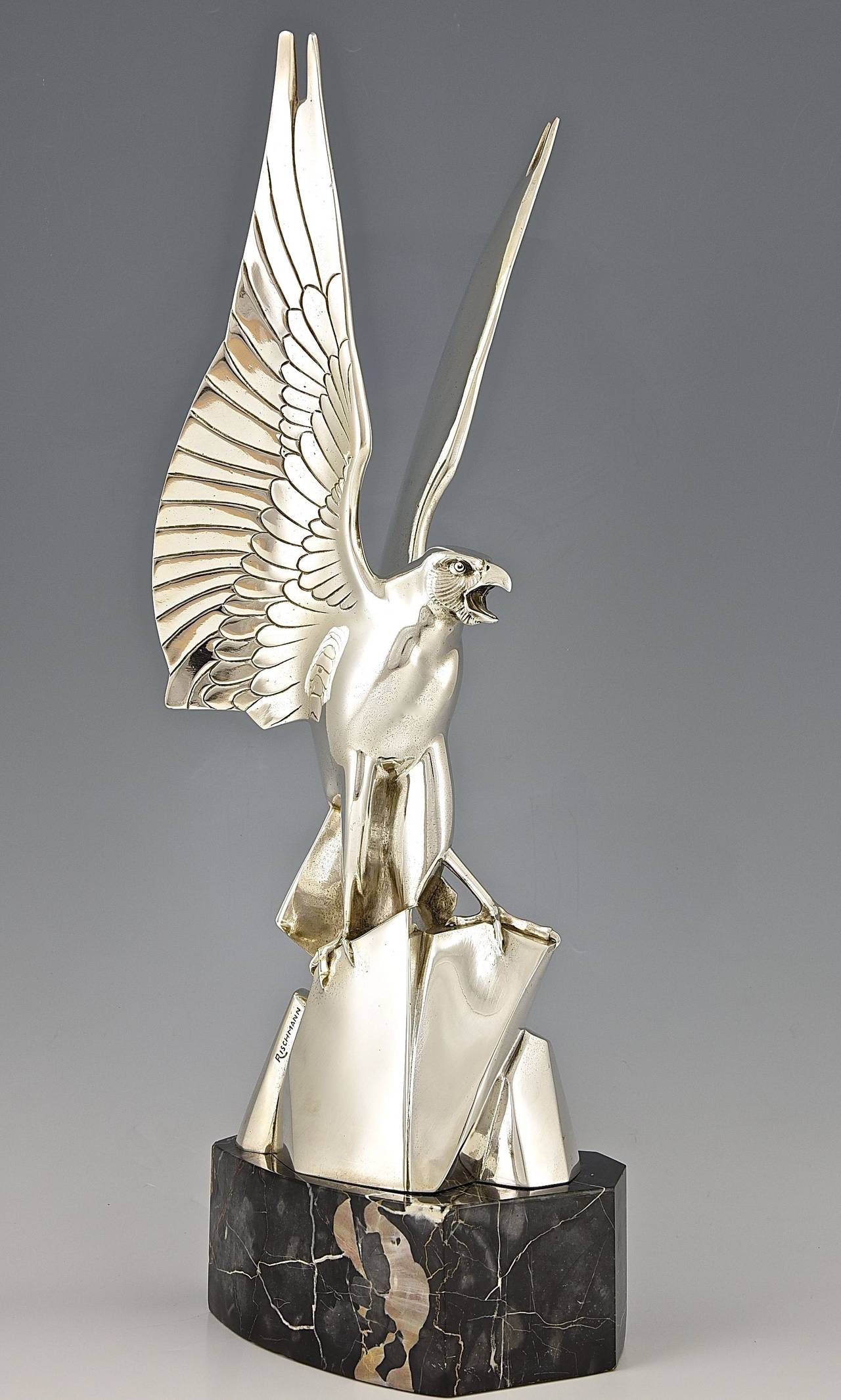 A silvered bronze Art Deco eagle on a marble base by  Henri Rischmann.

Date: circa 1925/1930

Size: 
H. 26.4 inch x L. 10.2 inch. X W. 7.9 inch. 
H. 67 cm x L. 26 cm. x W. 20 cm.  
 
Condition:  Very good condition, see pictures.