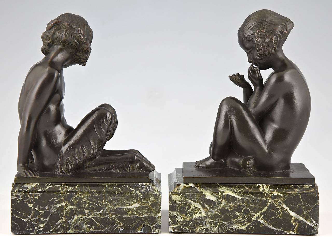 Art Deco bronze bookends of a young satyr and girl holding grapes. 
By Pierre Laurel.
Signature and Marks: Laurel.  Stamped number 102.
Style: Art Deco.
Condition:  Good original condition, see pictures. 

Date:  1925/1930.
Material: Bronze.