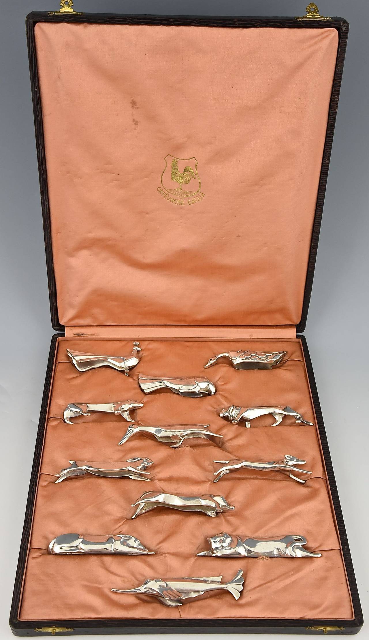 A set of 12 Art Deco silver plated animal knife rests in original case.
 By Gallia, Christofle.  Design by Sandoz for Gallia. 
Marks: Every piece has the Gallia stamp.  Original case marked Gallia 
Style:  Art Deco. 
Date:  1930. 
Material: