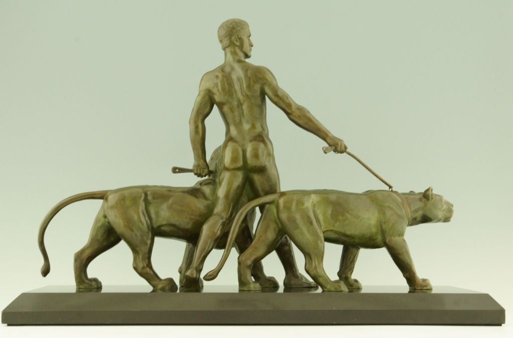 Art Deco bronze of a man with lion and lioness. 

Signed by Alexandre Ouline, worked in France 1918-1940.

“Animals in bronze” by Christopher Payne. Antique collectors club. 
“Dictionnaire des peintres, sculpteurs, dessinateurs et graveurs” by