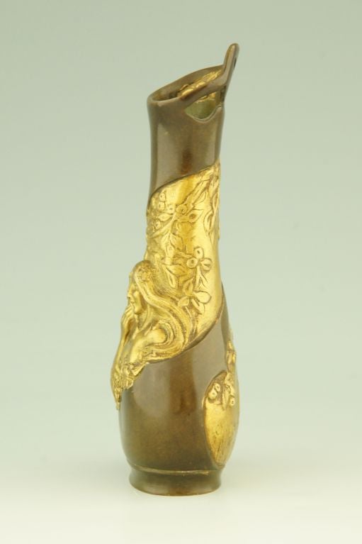 Fedex shipping: $ 125

A patinated and gilt bronze vase with a male and female face.
The background is decorated with flowers. 

Charles Korschann, Paris. Foundry stamp Louchet. 
 
Literature:
“Bronzes, sculptors and founders” by H. Berman,