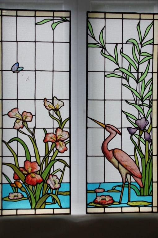 A beautiful and rare pair of stained and leaded glass window panels with heron, flowers and plants.
Original 1900.