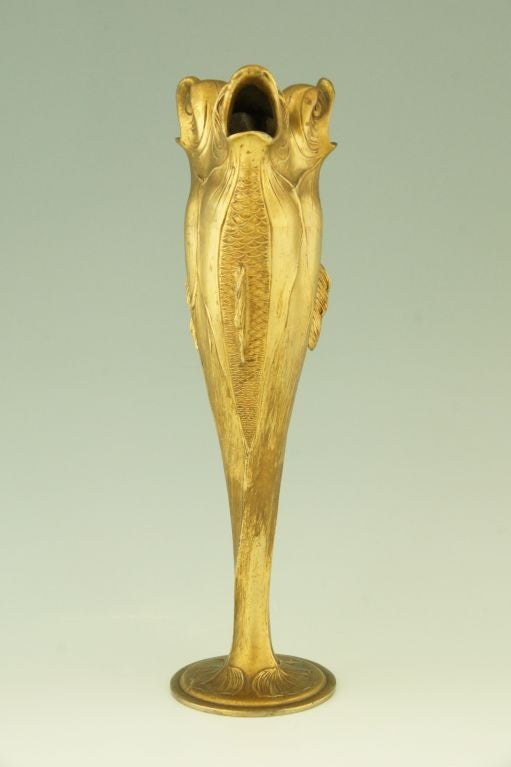 Fedex shipping: $125.

An art nouveau vase shaped like three upright fishes, their tails froming a circular foot. 
By Herman Gradl. 
Stamped and numbered Osiris.

This model is illustrated on page 180 of 
“Peter Behrens und Nürnberg“ ,