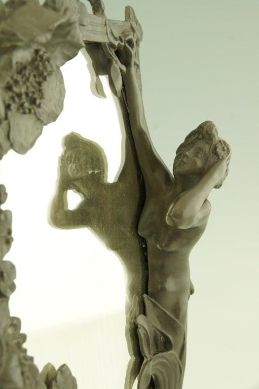 Art nouveau table mirror with a lady picking flowers to put in her hair. The frame decorated with flowers. 

Signed by Peyre, Raphael Charles.
France 1872-1949.

Literature:
“Etains 1900“ Philippe Dahan. Les éditions de l’amateur.