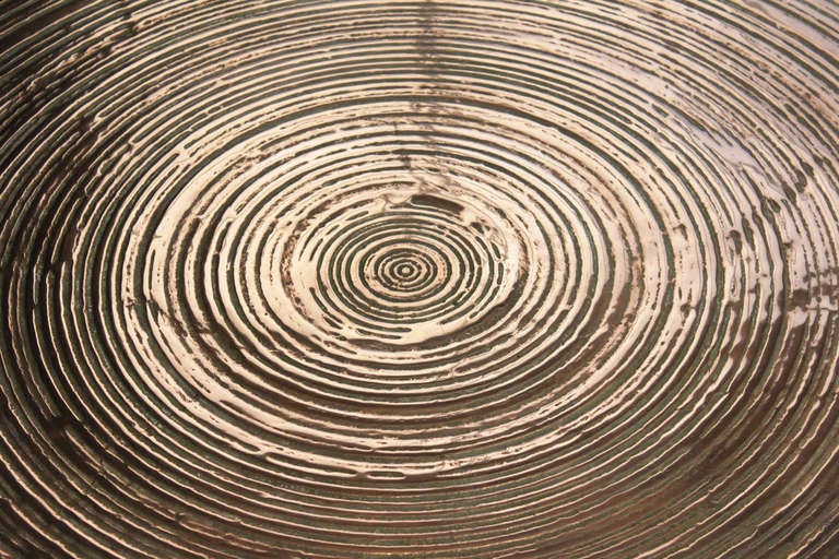Bronze coffee table by Ado Chale.

Bronze table top with concentric grooves, also known as 