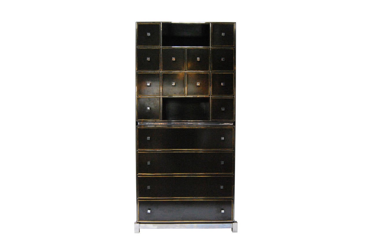 Elegant lacquered chest of drawers by Guy Lefevre for Maison Jansen.
Deep brown lacquered wood with brass details and aluminium handle.