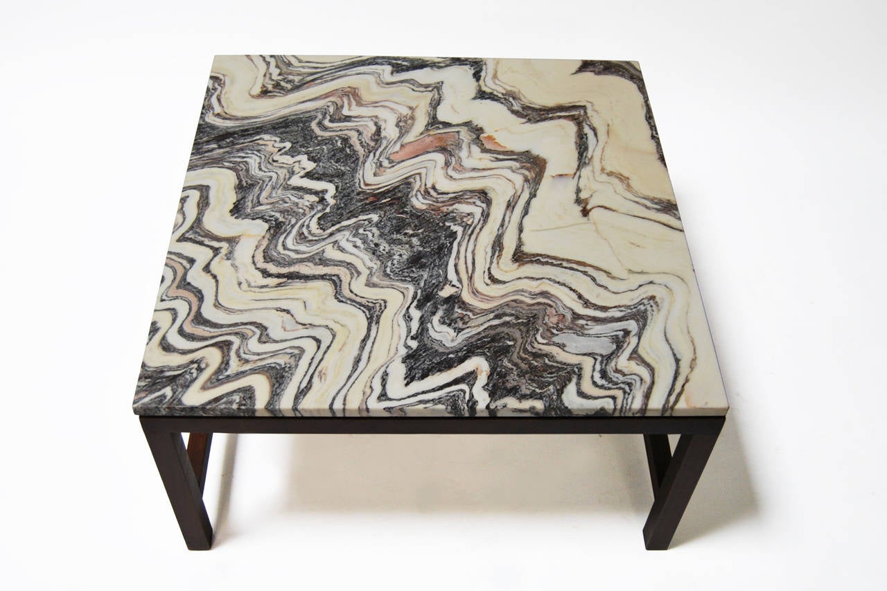Coffee table with a rosewood structure and a marble tabletop.